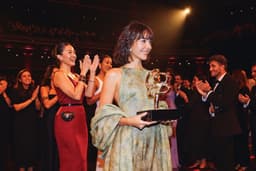 A trophy presentation moment at an awards gala