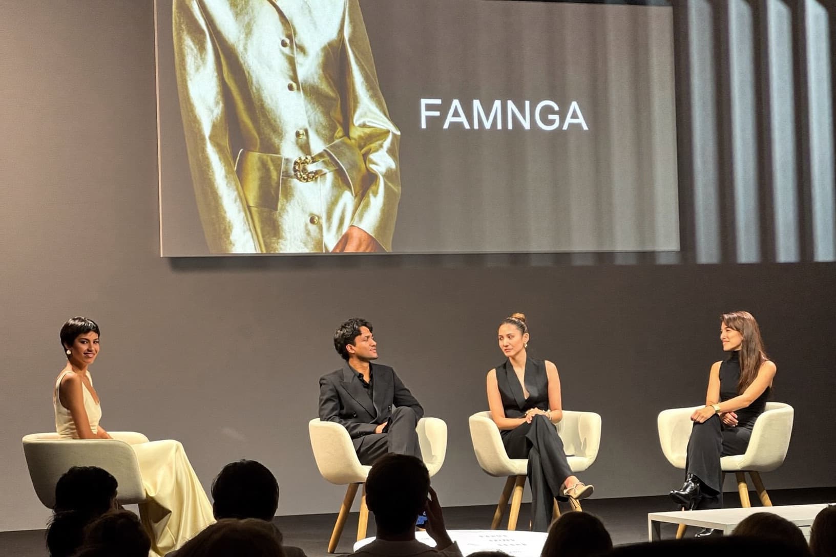 Panelists in conversation on a summit stage