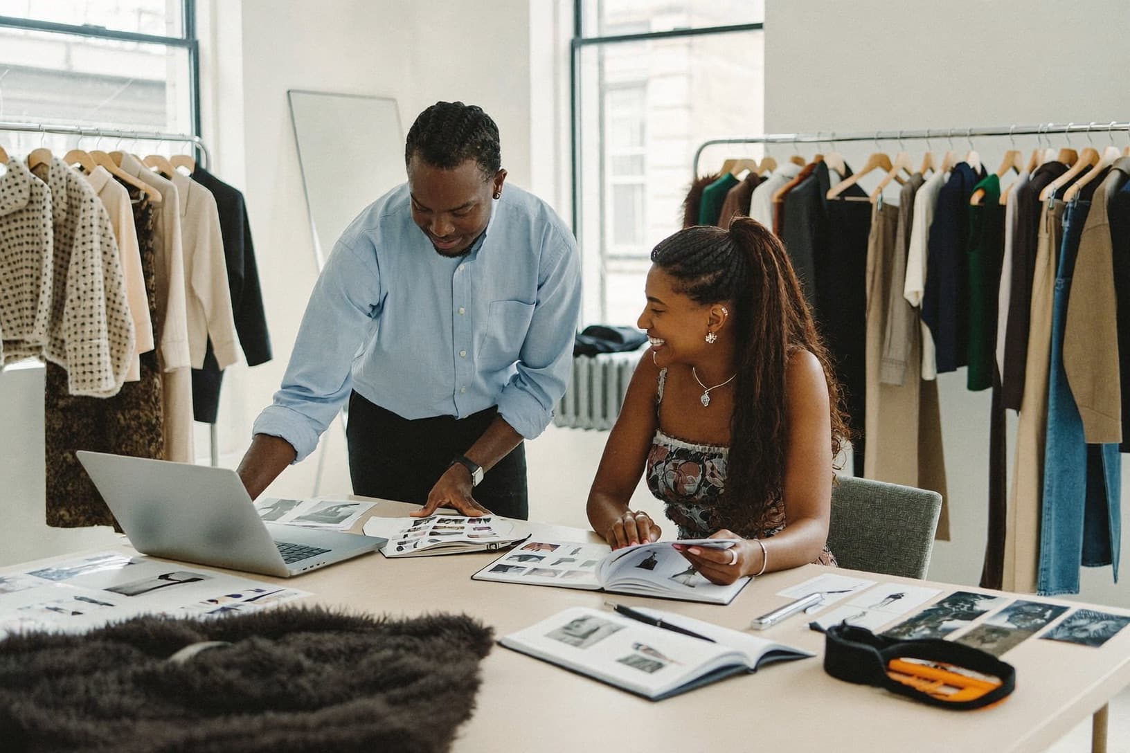 Two brand founders review a lookbook in their showroom