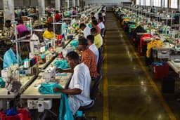 Workers at machines on a garment factory floor