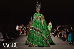A model in an emerald Ankara gown walks a Lagos runway